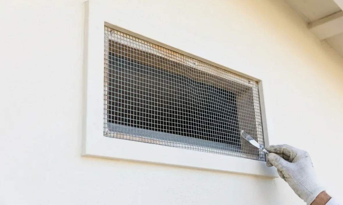Attic vent newly fitted with grey metal mesh to shut squirrels out Attic vent newly fitted with grey metal mesh to shut squirrels out